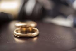 Discussing alimony, with wedding rings on the table. 